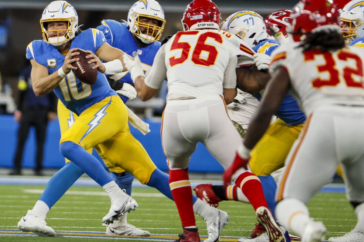 Chargers quarterback Justin Herbert escapes the pocket against the Kansas City Chiefs at SoFi Stadium
