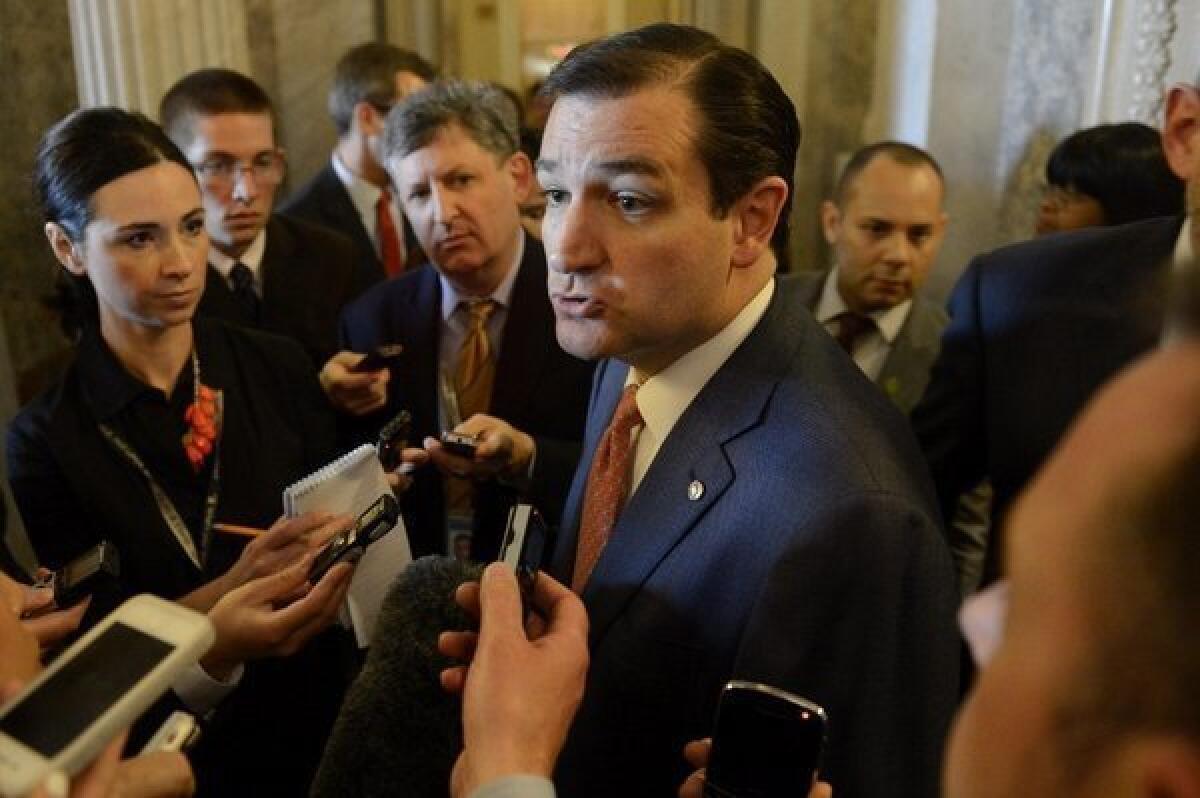 Republican Sen. Ted Cruz of Texas talks to journalists this week about his opposition to a proposal to require broader background checks on gun purchases.