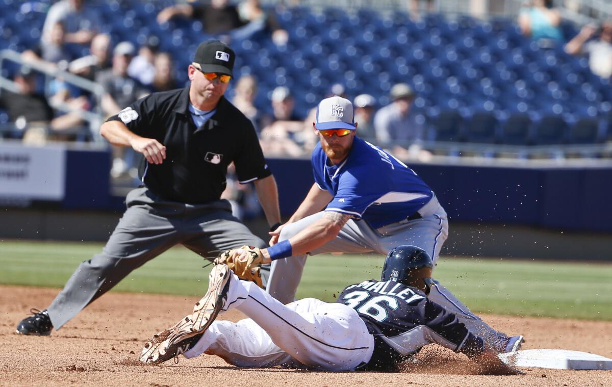 Seattle infielder Shawn O'Malley slides safely into second in front of Kansas City infielder Ryan Jackson during a game on March 26.