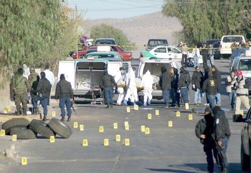 Law enforcement agents investigate the site of a shooting in Chihuahua, Mexico, in which seven people died.