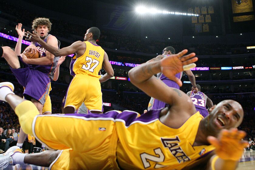 Skalij, Wally –– B58439698Z.1 LOS ANGELES, CALIFORNIA MAY 17, 2010–Suns RObin Lopez grabs a rebound from Lakers Ron Artest and a falling Kobe Bryant in Game 1 of the Western Conference Finals Monday. (Wally Skalij/Los Angeles Times)