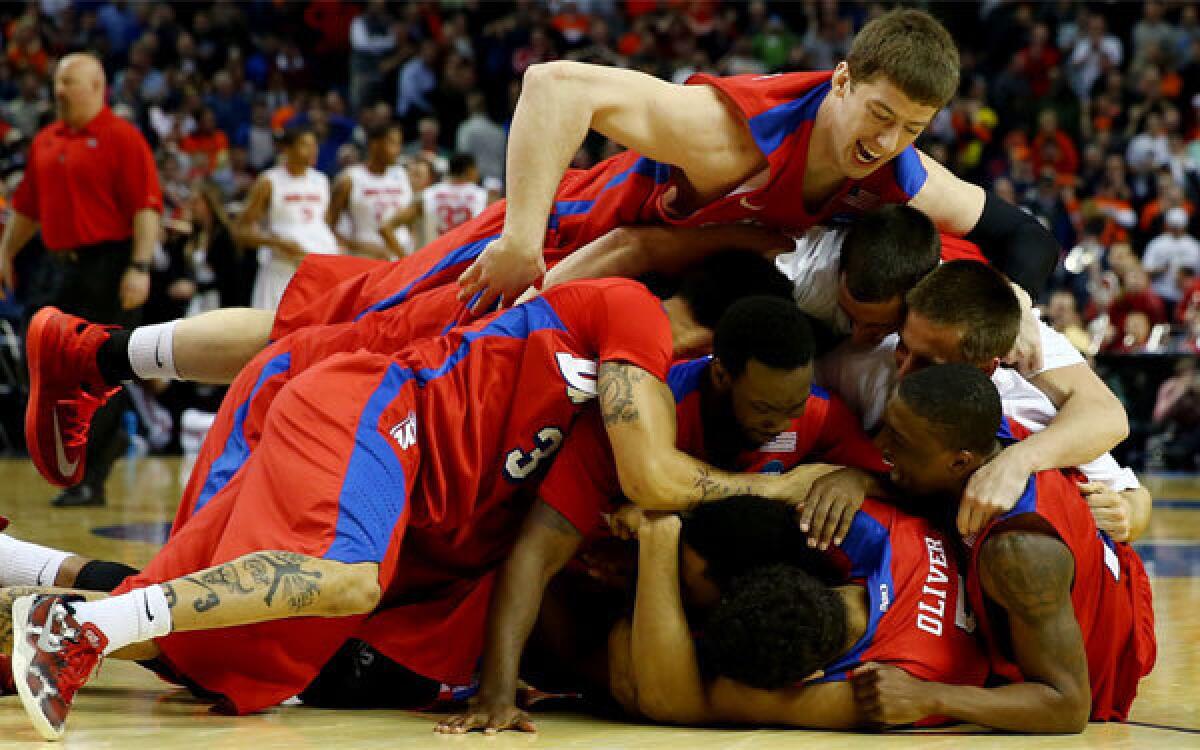 Dayton players celebrate after their 60-59 victory over Ohio State on Thursday.