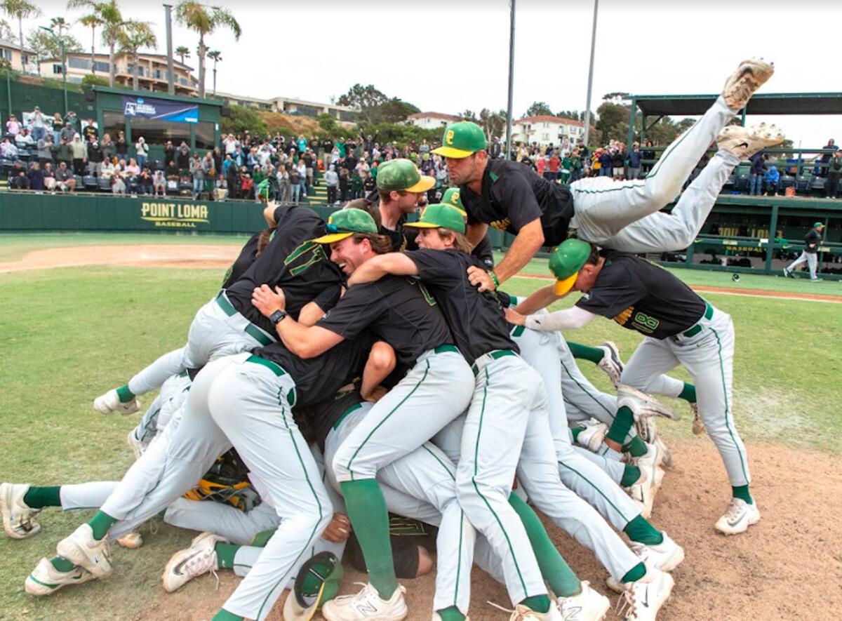 PLNU players dogpile on mound after beating Cal State Monterrey to advance to 2024 NCAA Division II national championships.