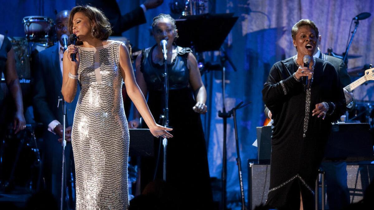 Whitney Houston, left, and Dionne Warwick sing "That's What Friends Are For" at the 2011 Clive Davis pre-Grammy gala at the Beverly Hilton.