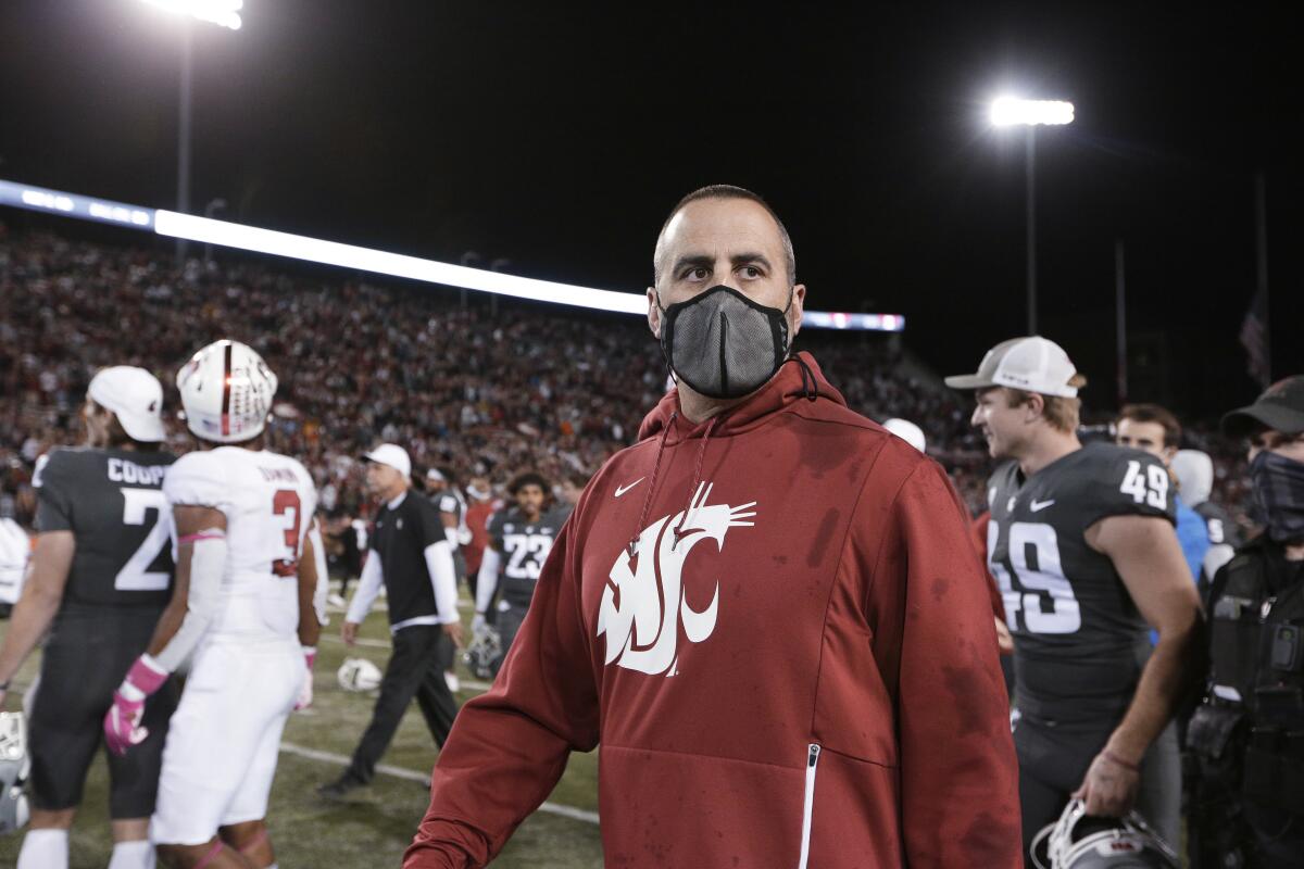 Washington State coach Nick Rolovich walks on the field after the team's win over Stanford