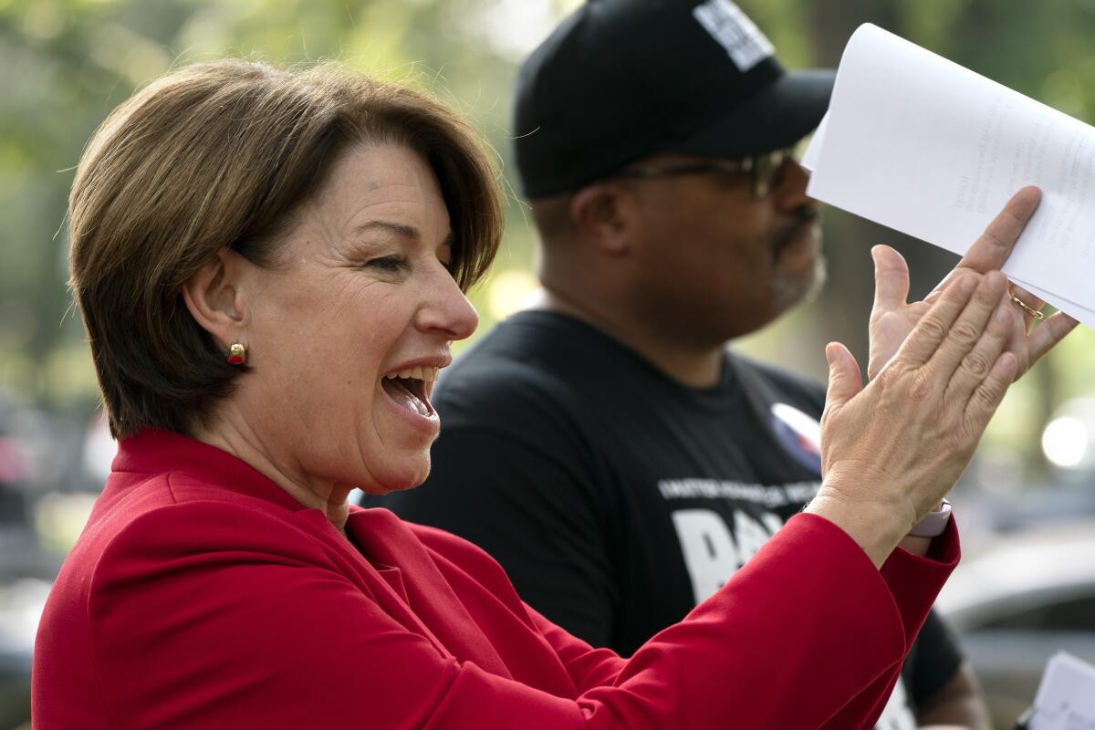 Sen. Amy Klobuchar, D-Minn., left, and Cliff Albright, executive director of Black Voters Matter, attend a rally for voting rights, Tuesday, Sept. 14, 2021, on Capitol Hill in Washington. (AP Photo/Jacquelyn Martin)
