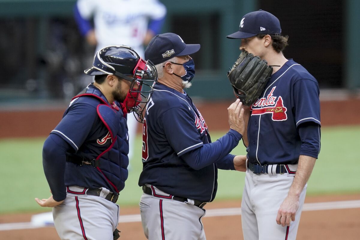 Atlanta Braves manager Brian Snitker talks with starting pitcher Max Fried during the first inning.