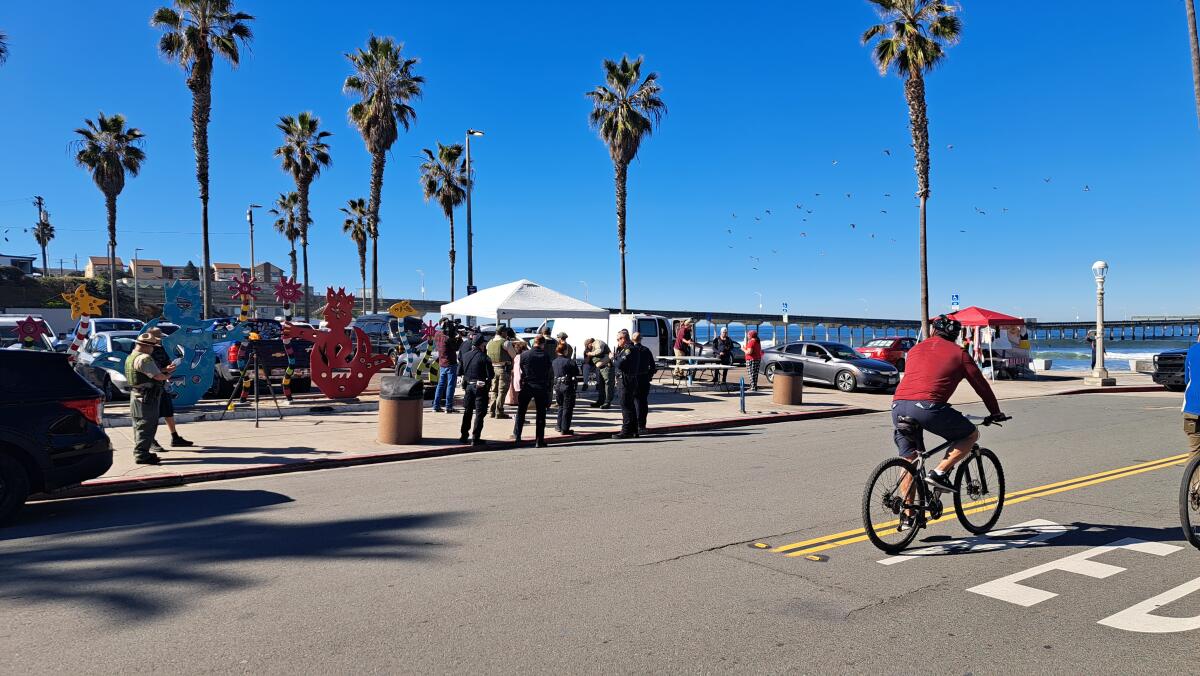 Park rangers, accompanied by San Diego police officers, conduct vendor enforcement Feb. 1 in Ocean Beach.