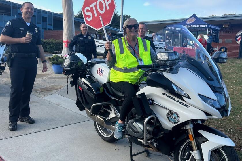 Pictured is Kathy Japes on a police motorcycle during Eastbluff Elementary School's Red Ribbon week. Japes was injured in a traffic accident on Feb. 13.