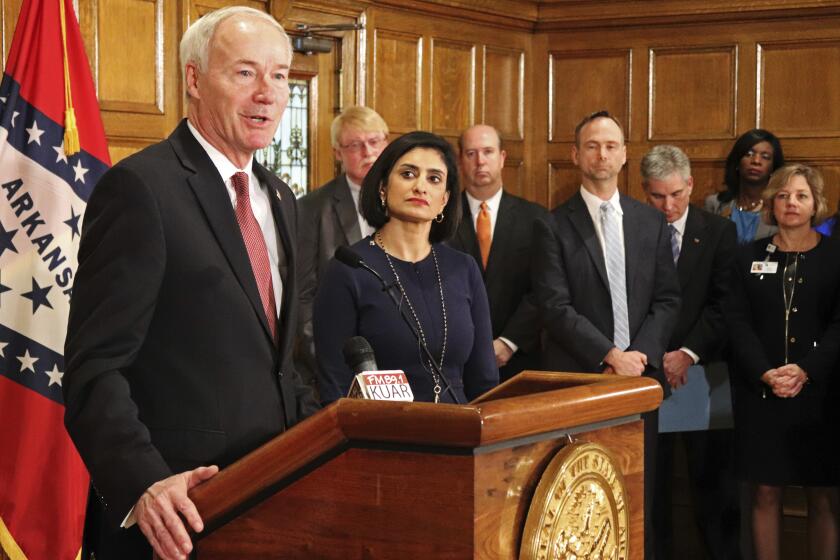 Gov. Asa Hutchinson speaks at a news conference Monday, March 5, 2018, at the state Capitol in Little Rock, Ark., with Seema Verma, the head of the Centers for Medicare and Medicaid Services. Verma on Monday approved a state plan to require that thousands of people on its Medicaid expansion seek ways to work or volunteer. Traditional Medicaid recipients are not affected. Arkansas is the third state to win permission, following Kentucky and Indiana. (AP Photo/Kelly P. Kissel)
