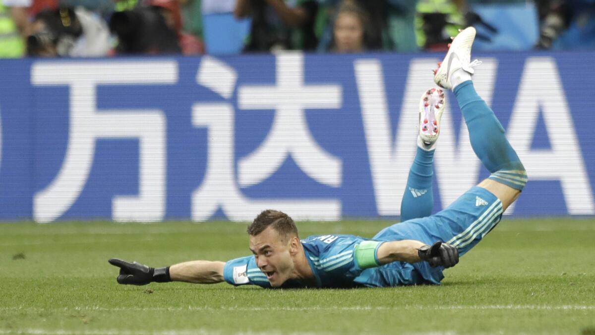 Russia goalkeeper Igor Akinfeev celebrates Sunday, July 1, 2018, after his team advances to the quarterfinal during the round of 16 match between Spain and Russia.