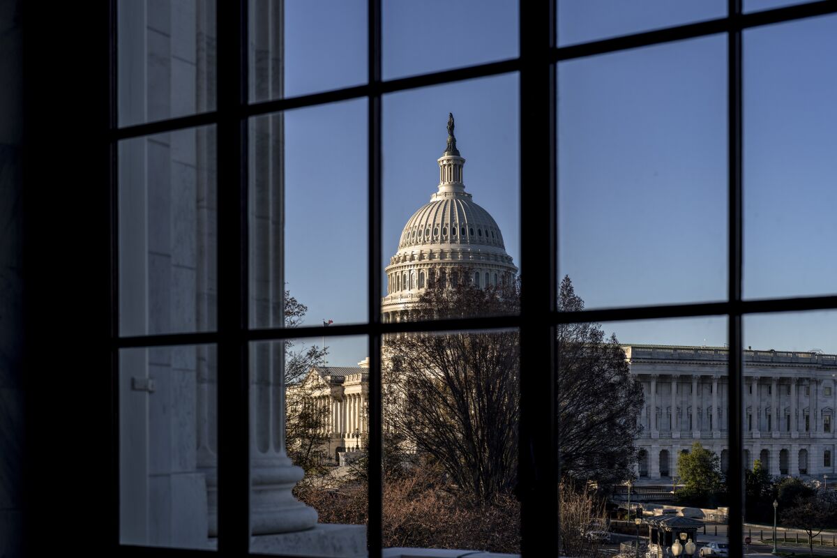 FILE - The Capitol is seen through a window in the Russell Senate Office Building as policymakers wrestle with fallout from the failure of Silicon Valley Bank, in Washington, March 15, 2023. While President Joe Biden called Monday on Congress to strengthen the rules for banks to prevent future failures, lawmakers are divided on whether any legislation is needed. (AP Photo/J. Scott Applewhite, File)