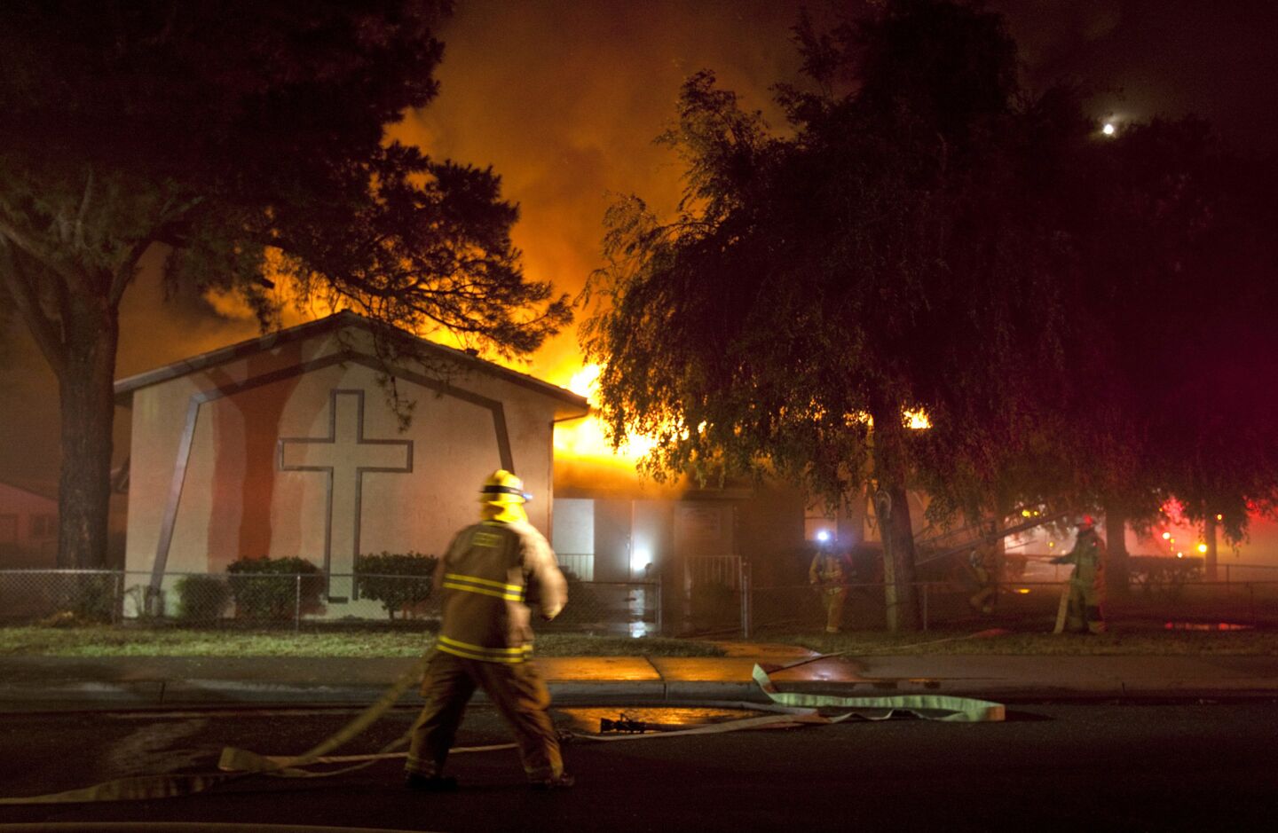 Calvary Assembly Church on Cedar Street in downtown Escondido is engulfed in flames. Crews battling wildfires in the area saw their resources stretched further by the church fire.