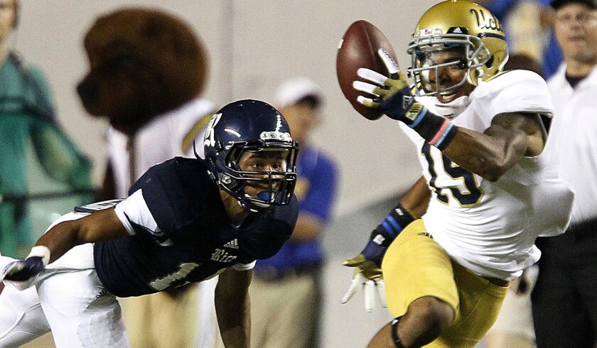 Devin Lucien, hauling in a pass against Rice last season, gives the Bruins a deep threat at receiver.