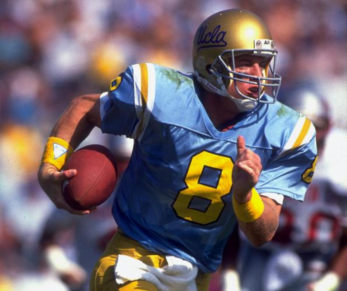 UCLA's Troy Aikman runs with the ball.