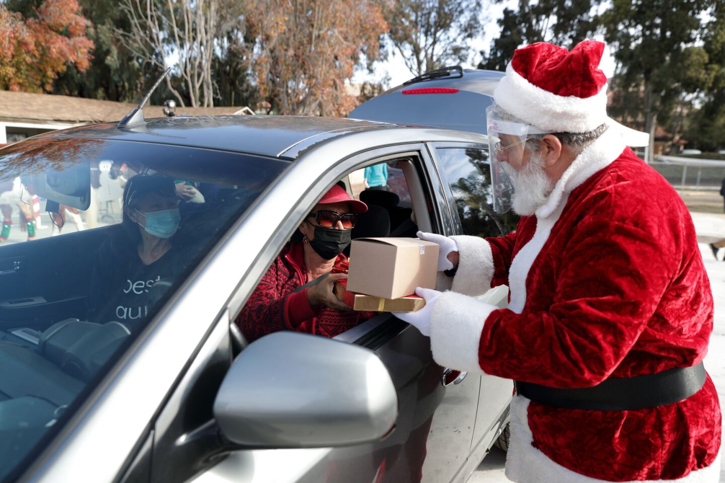 Santa greets Sandra Logan with AniMeals gifts