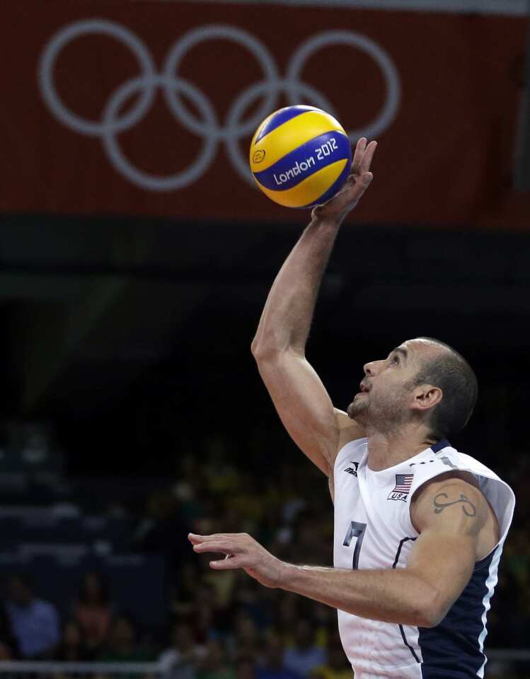 United States' Donald Suxho serves during a men's preliminary volleyball match against Brazil.