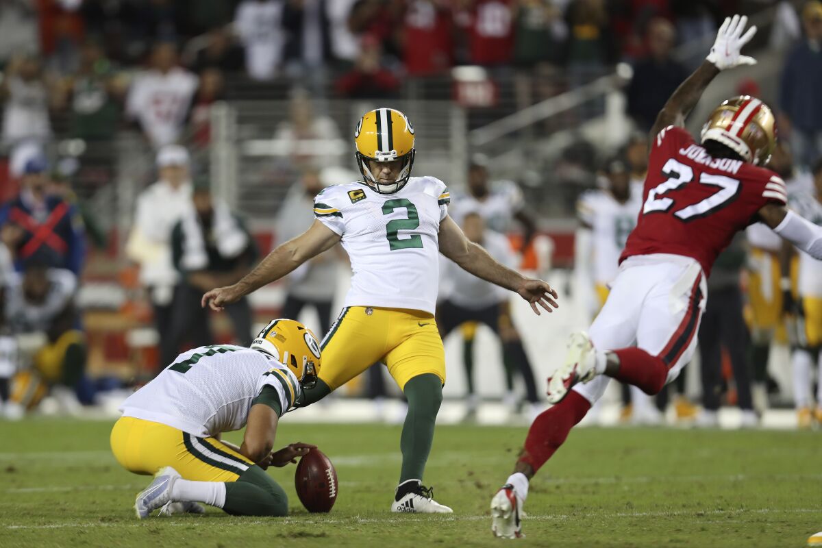 FILE -Green Bay Packers kicker Mason Crosby (2) kicks the game winning field goal from the hold of Corey Bojorquez during the second half of an NFL football game against the San Francisco 49ers in Santa Clara, Calif., Sunday, Sept. 26, 2021. The Packers and 49er meet Saturday, Jan. 22, 2022.(AP Photo/Jed Jacobsohn, File)