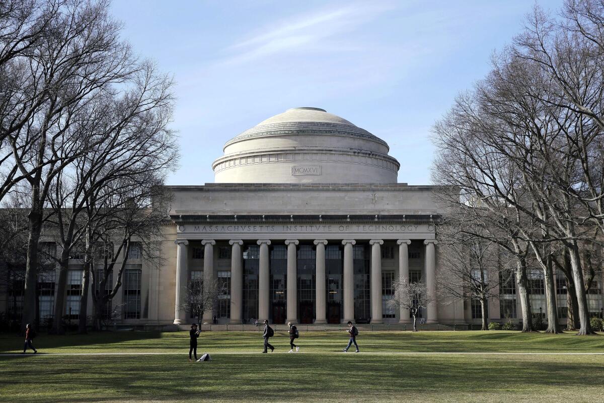 Students walk on the MIT campus. 