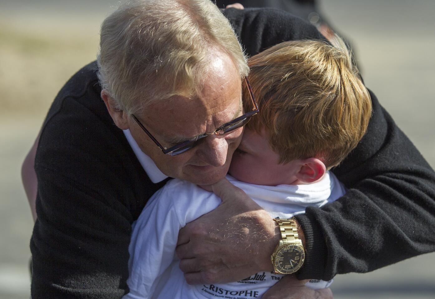 Anders Manson hugs his grandson Liam McCarthy, 7, after running in the Newport Elementary School's annual jog-a-thon on Wednesday.