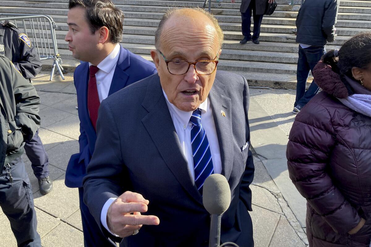Former New York City mayor Rudy Giuliani speaks to reporters 
