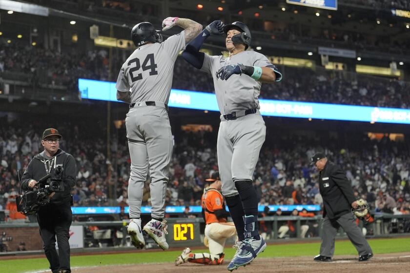New York Yankees' Aaron Judge, front right, is congratulated by Alex Verdugo (24) for a home run against the San Francisco Giants during the sixth inning of a baseball game in San Francisco, Friday, May 31, 2024. (AP Photo/Jeff Chiu)
