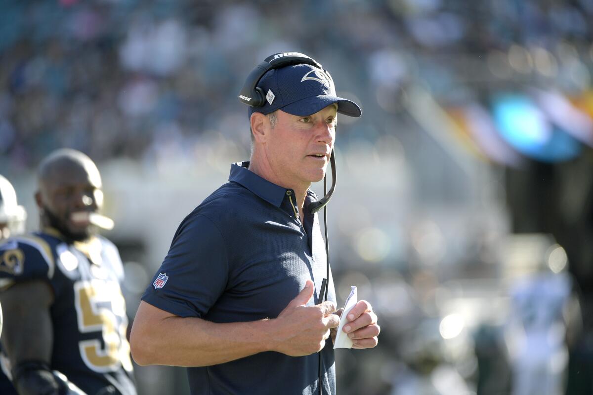 Rams offensive line coach Aaron Kromer works along the sideline during a game.