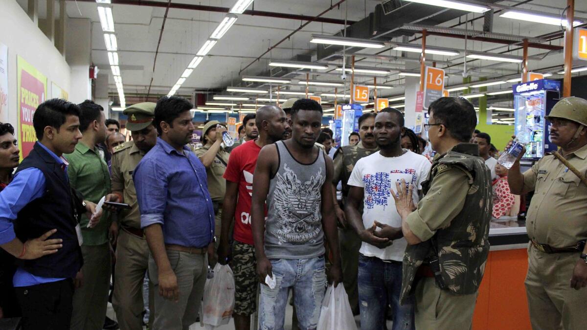 Indian police and onlookers surround a group of African nationals at a shopping mall in Greater Noida, India.