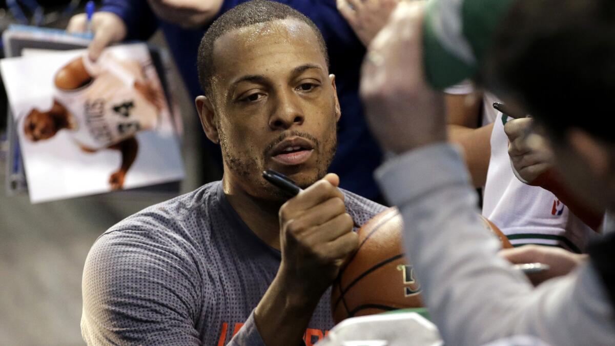 Clippers forward Paul Pierce signs autographs for fans before his final game in Boston on Sunday.