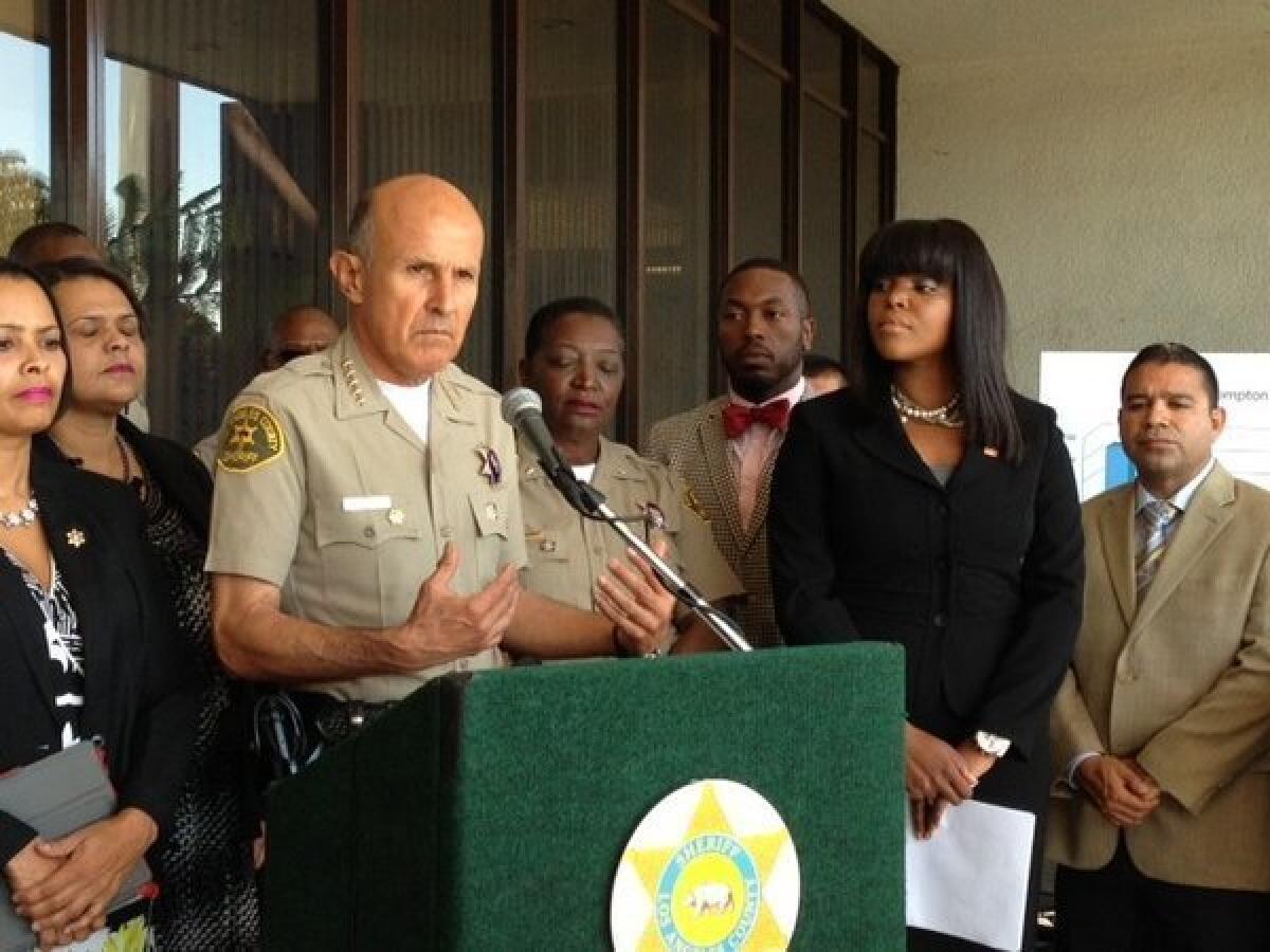 At a news conference at Compton City Hall, Los Angeles County Sheriff Lee Baca addresses a recent increase in crime in the city. He is accompanied by Mayor Aja Brown, right.