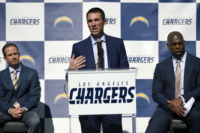 Los Angeles Chargers general manager Tom Telesco, center, introduces Anthony Lynn, right, as the team's new head coach, as president of football operations John Spanos looks on during an NFL football news conference in Carson, Calif., Tuesday, Jan. 17, 2017. (AP Photo/Kelvin Kuo)