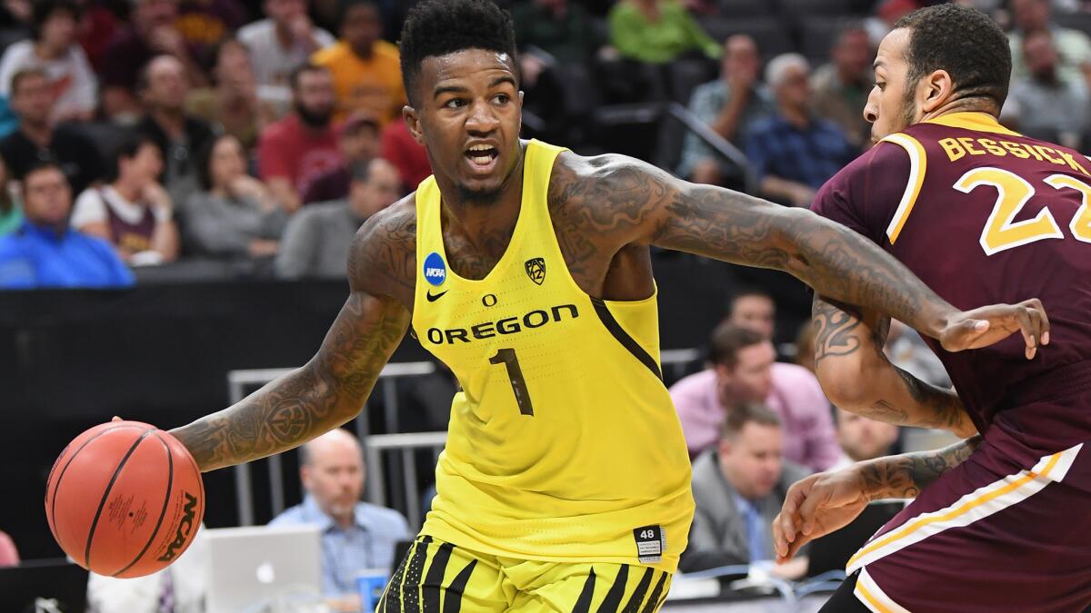 Oregon guard Jordan Bell drives past Iona forward Taylor Bessick during the first half.