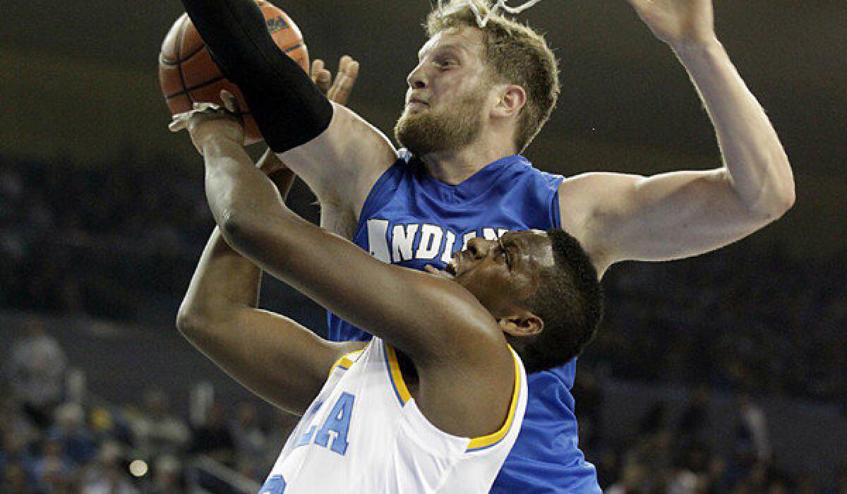 UCLA guard Jordan Adams is fouled going hard to the hoop against Indiana State forward Jake Kitchell.