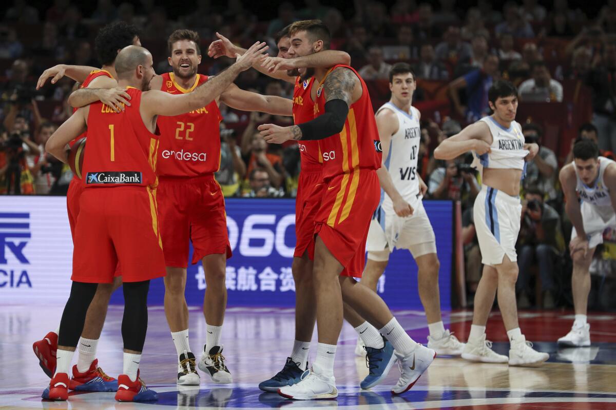 Spanish players celebrate after defeating Argentina in the FIBA Basketball World Cup final Sunday in Beijing.