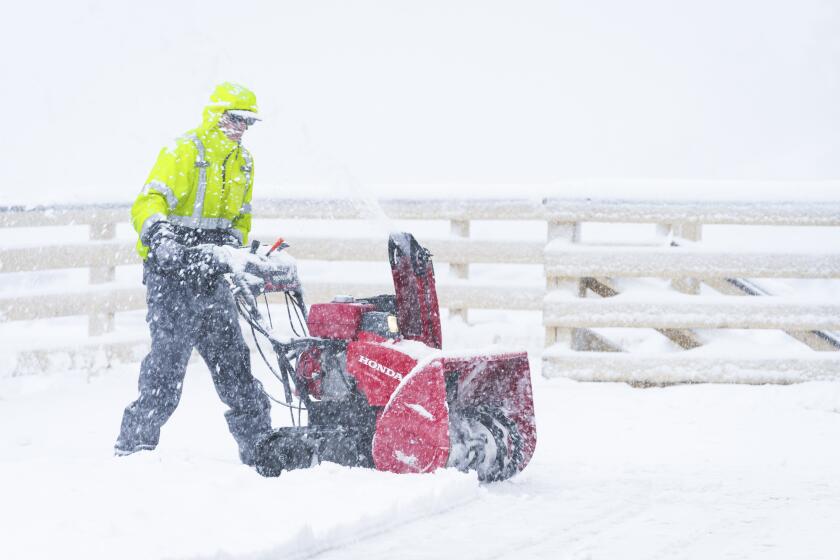 Snow is cleared on the Big Mountain Resort property during a storm, Saturday, March 30, 2024, in Big Bear Lake, Calif. (Big Mountain Resort via AP)