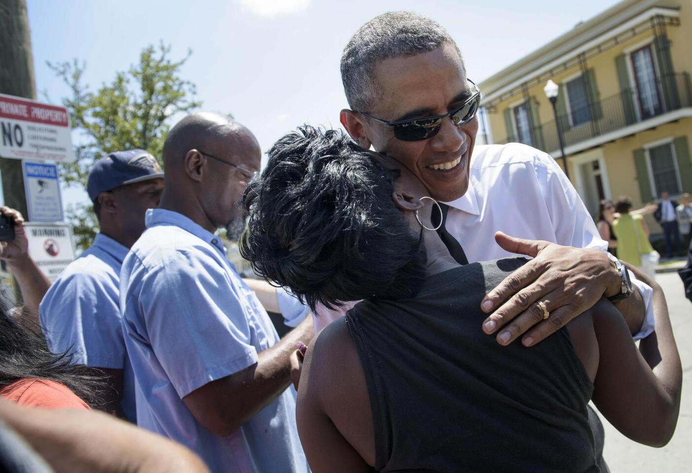 President Barack Obama hugs a woman during a tour of New Orleans' Treme neighborhood Aug. 27, 2015.