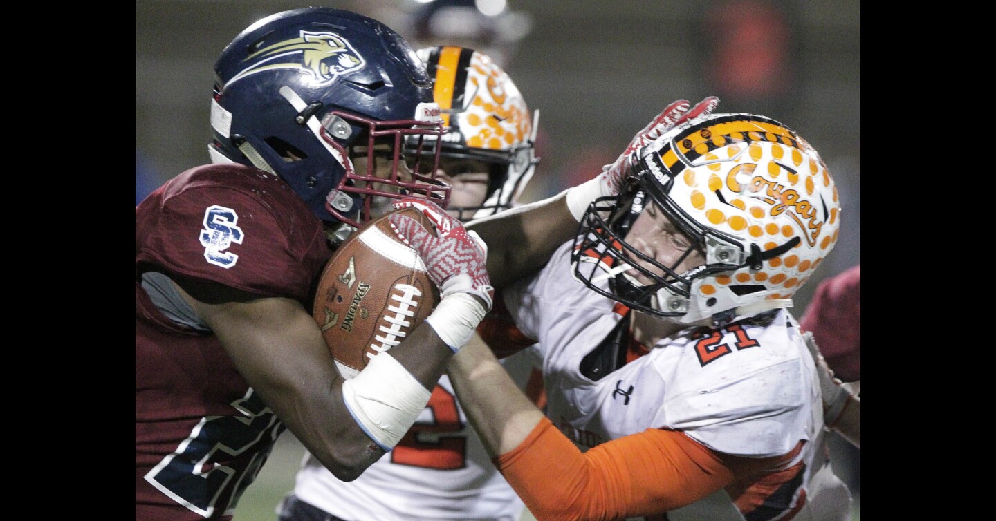 Steele Canyon's Kenneth Watson runs into Half Moon Bay's Chase Hofmann during the fourth quarter.