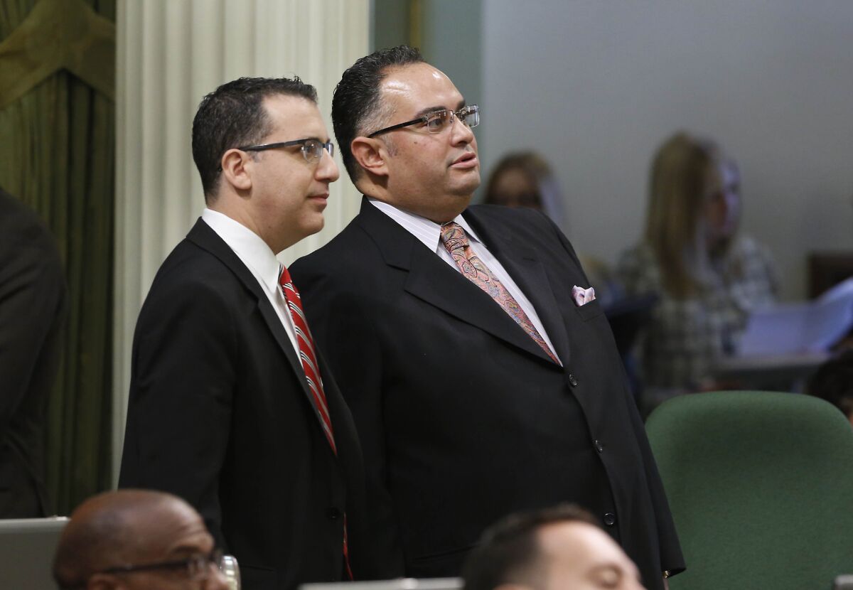 Assemblyman Bob Blumenfield (D-Sherman Oaks), left, chairman of the Assembly Budget Committee, and Assembly Speaker John Perez (D-Los Angeles) watch as the votes for the state budget are posted at the Capitol last week.