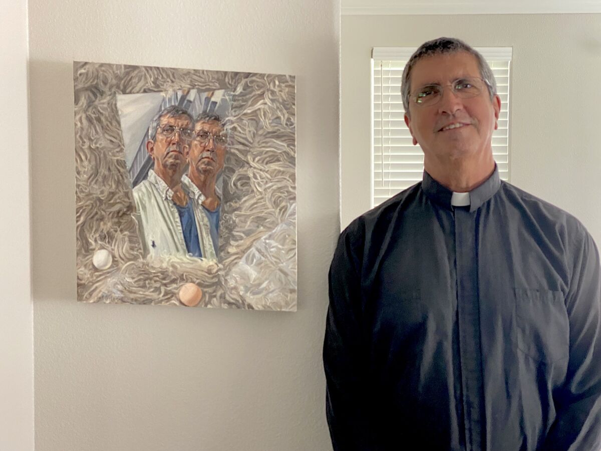 Artist Michael Sitaras at home, with his double self-portrait.