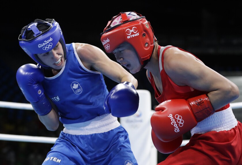 FILE - In this Aug. 2, 2016, file photo, Canada's Mandy Bujold, left, knocks down Uzbekistan's Yodgoroy Mirzaeva during a women's flyweight 51-kg preliminary boxing match at the Summer Olympics in Rio de Janeiro, Brazil. The Tokyo Olympics fate for Canada’s best boxer lies in the hands of the Court of Arbitration for Sport after her qualifying tournament was scrapped due to the pandemic. Bujold and her lawyer, Sylvie Rodrigue, lost their appeal to the International Olympic Committee earlier this week, leaving CAS as her last chance to box in what would be her final Olympics. (AP Photo/Frank Franklin II, File)