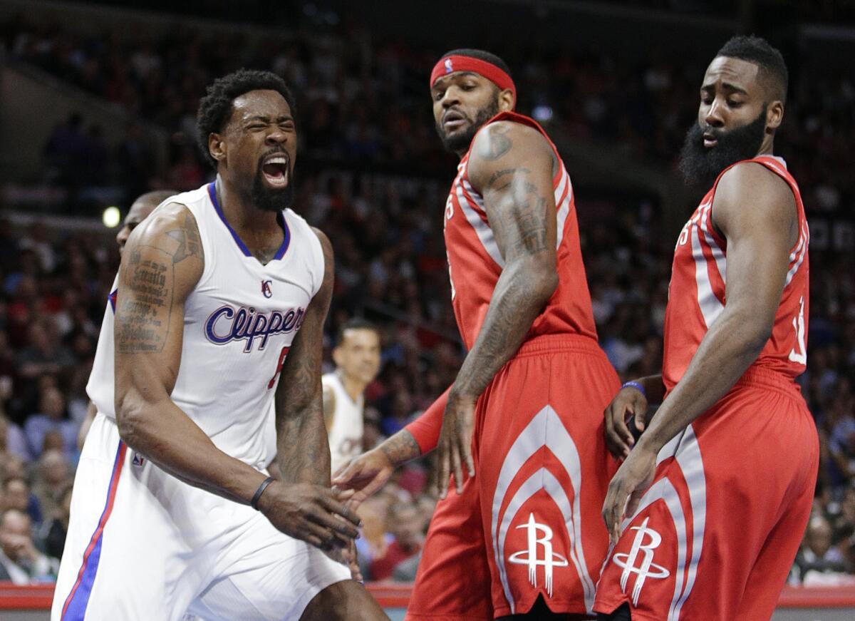 DeAndre Jordan, left, celebrates a basket as Houston's Josh Smith, center, and James Harden watch.