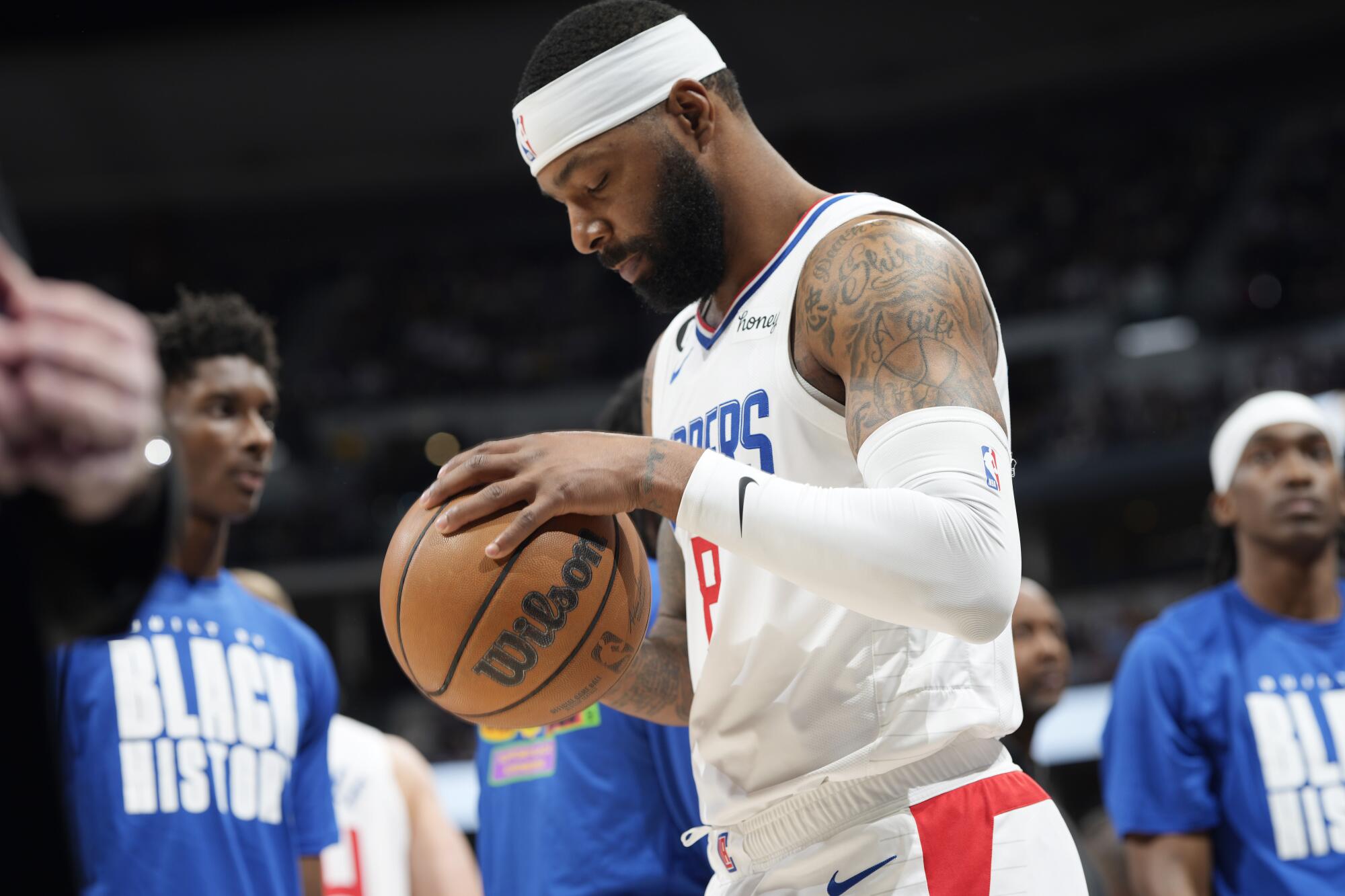 Clippers forward Marcus Morris Sr. grabs the basketball with both hands during a break in play.