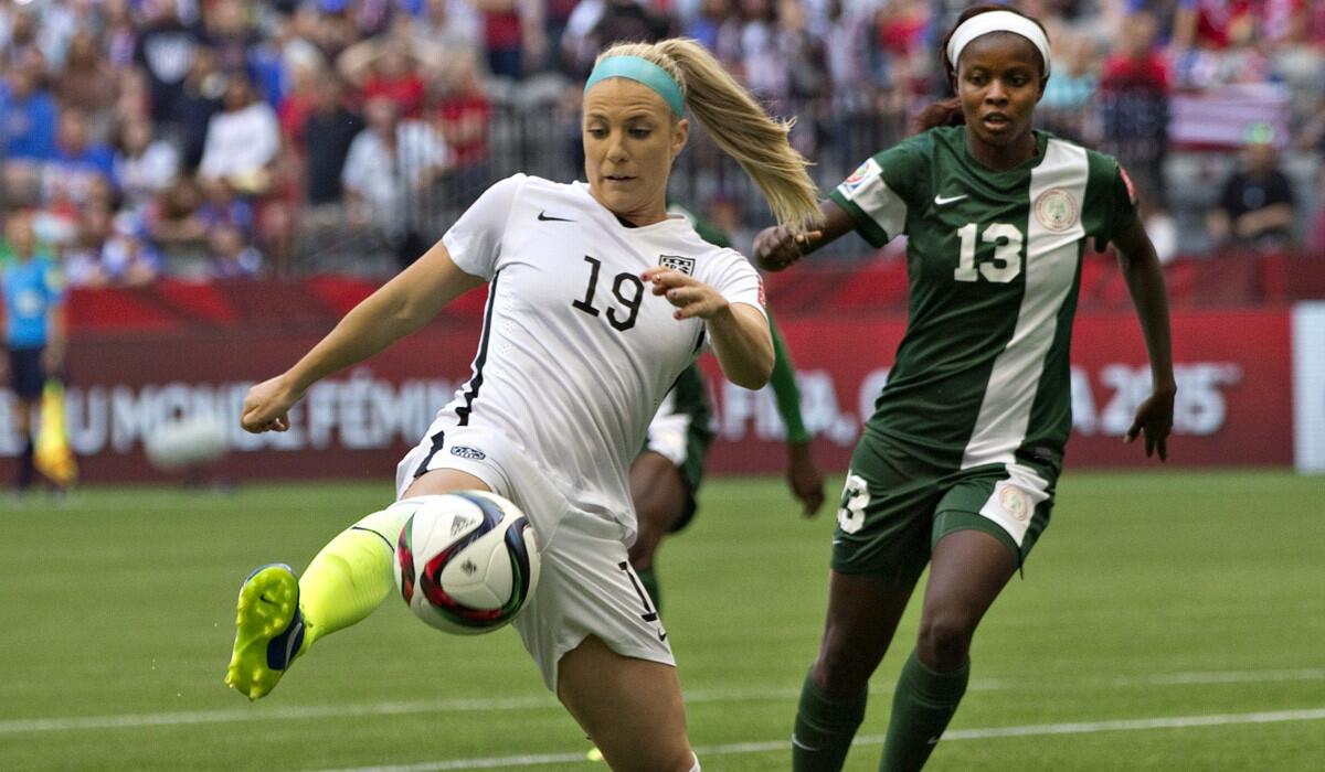 USA defender Julie Johnston and Nigeria forward Ngozi Okobi fight for the ball during a match at the FIFA Women's World Cup on Tuesday.