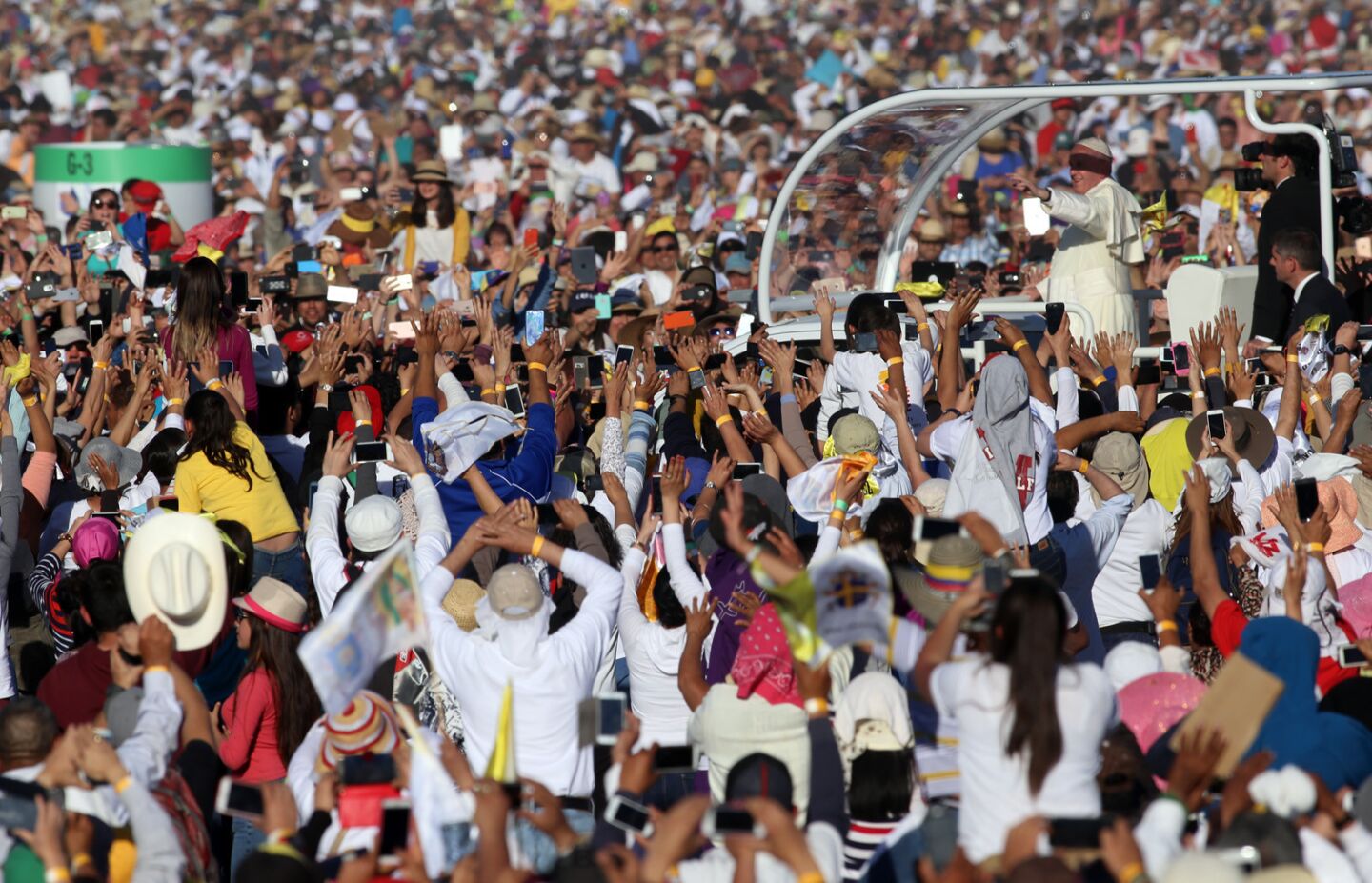Pope Francis rides through a crowd of pilgrims at El Punto fairgrounds in Ciudad Juarez, Mexico.