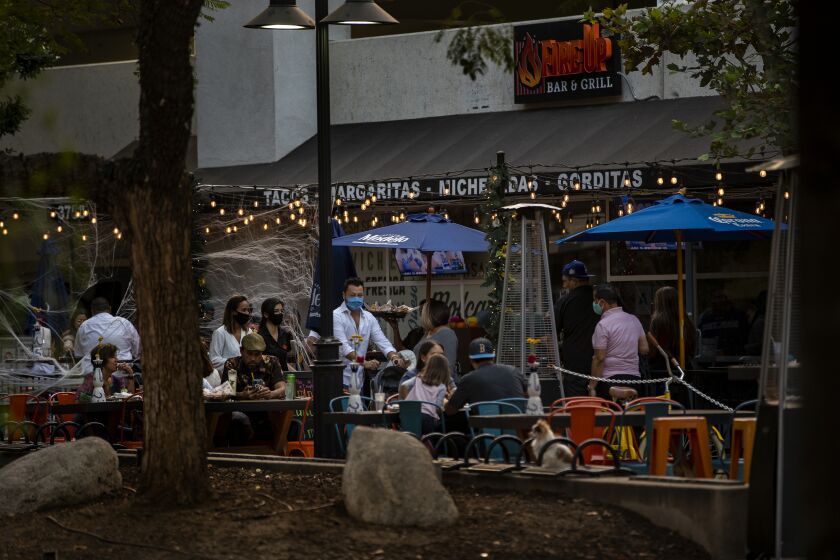 RIVERSIDE, CA - OCTOBER 21, 2020: The outdoor seating area at Fire Up Bar & Grill is crowded as rising coronavirus rates forced Riverside County back into the most restrictive tier of the state's coronavirus reopening framework on October 21, 2020 at the Riverside Plaza in Riverside, California. The new health ruling means that restaurants, gyms, movies theaters and places of worship can no longer have limited indoor operations.(Gina Ferazzi / Los Angeles Times)
