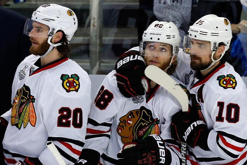 Chicago Blackhawks teammates (from left) Brandon Saad, Patrick Kane and Patrick Sharp look on from the bench during the final moments of Game 5 of the Stanley Cup Final against the Tampa Bay Lightning on June 13.