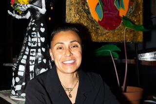 DJ Leslie Ortiz, host of Toxica Fridays at Mi Corazon in Silverlake, gets inspired by the restaurant's Latinx decoration on Friday, April 26, 2024.