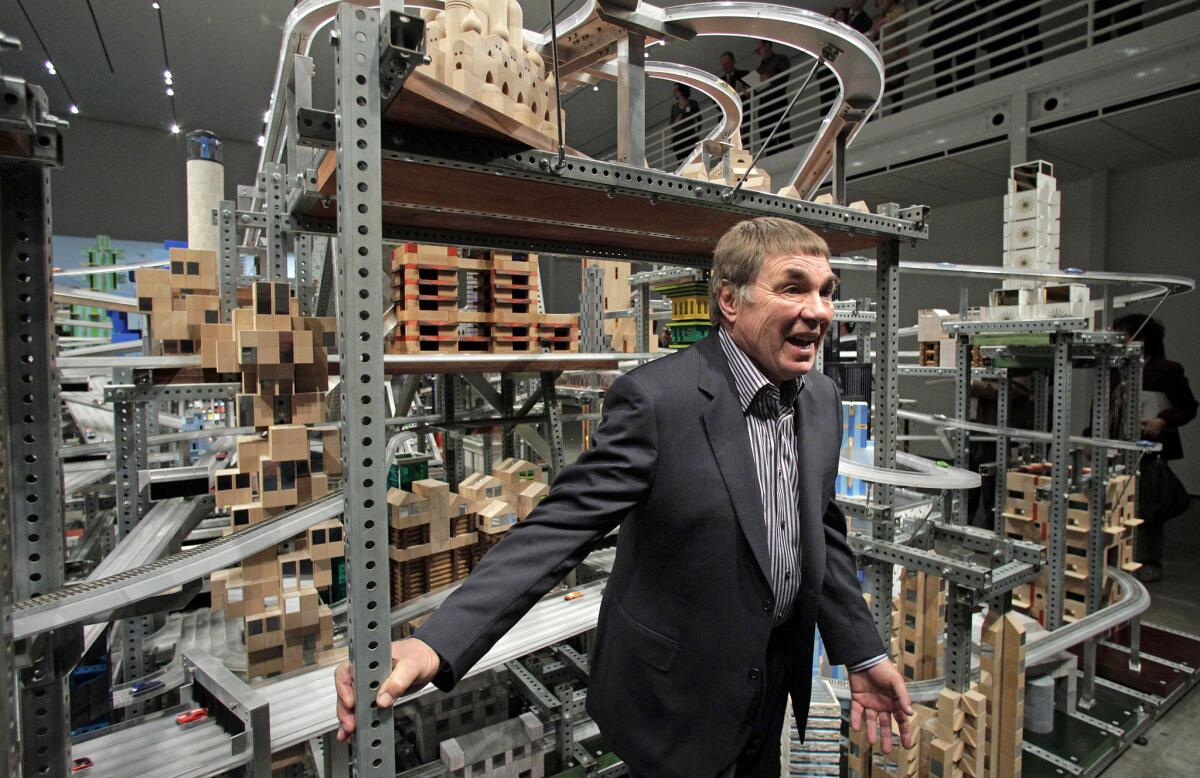 In this 2012 photo, Chris Burden stands in front of his kinetic sculpture "Metropolis II" at the Los Angeles County Museum of Art.