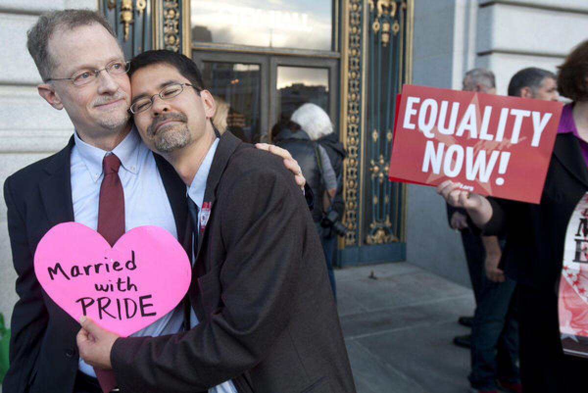 John Lewis, left, and Stuart Gaffney embrace outside San Francisco City Hall in anticipation of Wednesday's U.S. Supreme Court ruling that cleared the way for same-sex marriages to resume in California