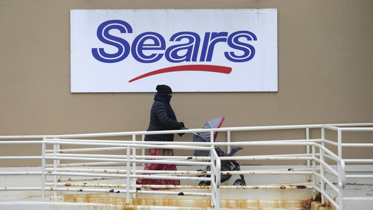 A person walks near a Sears store in Hackensack, N.J.